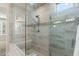 Glass enclosed walk-in shower featuring bench and decorative tile accents at 16945 W Vernon Ave, Goodyear, AZ 85395