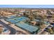 Aerial view of multiple community tennis courts, lush landscaping, and surrounding houses on a sunny day at 16945 W Vernon Ave, Goodyear, AZ 85395