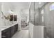 Spa-like bathroom features a glass shower, dual vanities, and seamless transition to the main bedroom at 18007 N 66Th Way, Phoenix, AZ 85054