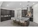 Modern kitchen featuring stylish island seating, a stainless steel range hood, and dark cabinets at 18007 N 66Th Way, Phoenix, AZ 85054