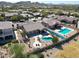 A beautiful aerial view of a backyard featuring pools and green landscaping at 18178 W Desert View Ln, Goodyear, AZ 85338