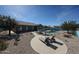 Inviting backyard featuring a pool, sun lounging area, and desert landscaping at 18178 W Desert View Ln, Goodyear, AZ 85338