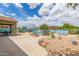Expansive backyard with a private pool, mature landscaping, and a covered patio area at 18178 W Desert View Ln, Goodyear, AZ 85338