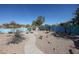 A backyard showcasing desert landscaping with cacti and trees, and a winding stone pathway at 18178 W Desert View Ln, Goodyear, AZ 85338