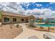 Spacious backyard featuring a private pool, mature desert landscaping, and covered patio at 18178 W Desert View Ln, Goodyear, AZ 85338