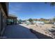 A covered patio extends from the home into a backyard featuring desert landscaping and a sparkling pool at 18178 W Desert View Ln, Goodyear, AZ 85338