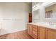 Bathroom vanity with dual sinks, wood cabinets, and lots of counter space at 18178 W Desert View Ln, Goodyear, AZ 85338