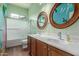 Bathroom featuring a double sink vanity and a tub shower combo at 18178 W Desert View Ln, Goodyear, AZ 85338