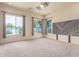 Bright bedroom with carpet, three windows, and a ceiling fan at 18178 W Desert View Ln, Goodyear, AZ 85338