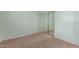 Bedroom featuring soft carpet, light green walls, and mirrored closet doors at 18178 W Desert View Ln, Goodyear, AZ 85338