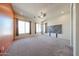 Expansive bedroom features plush carpet, large windows, ceiling fan, and decorative accent wall at 18178 W Desert View Ln, Goodyear, AZ 85338