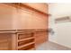 Walk-in closet with multiple shelving units and rods for organizing clothing at 18178 W Desert View Ln, Goodyear, AZ 85338