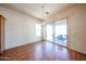 Dining area with wood floors and a modern light fixture next to sliding doors to the patio at 18178 W Desert View Ln, Goodyear, AZ 85338