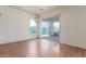 Bright dining room with a sliding glass door and hardwood floors at 18178 W Desert View Ln, Goodyear, AZ 85338