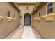 Charming single-story home featuring a welcoming entrance with attractive desert landscaping and a stylish blue door at 18178 W Desert View Ln, Goodyear, AZ 85338