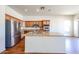 Bright kitchen features a center island with granite countertops, stainless steel appliances and wood cabinets at 18178 W Desert View Ln, Goodyear, AZ 85338