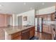 Kitchen island with granite countertops and stainless steel appliances at 18178 W Desert View Ln, Goodyear, AZ 85338