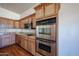 Kitchen features stainless steel appliances, wooden cabinets and granite countertops at 18178 W Desert View Ln, Goodyear, AZ 85338