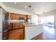 Bright kitchen features a center island with granite countertops, stainless steel appliances and wood cabinets at 18178 W Desert View Ln, Goodyear, AZ 85338