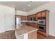 Kitchen with granite countertops, stainless appliances, and wood cabinets at 18178 W Desert View Ln, Goodyear, AZ 85338