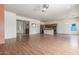 Open-concept living space with wood floors seamlessly connects the living room, dining area, and kitchen at 18178 W Desert View Ln, Goodyear, AZ 85338