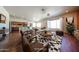 Inviting living room featuring hardwood floors, stylish furniture, and seamless access to the kitchen at 18178 W Desert View Ln, Goodyear, AZ 85338