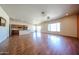 Open-concept living room with wood floors and lots of natural light, adjacent to the kitchen at 18178 W Desert View Ln, Goodyear, AZ 85338