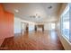 Bright living room with wood floors and views of the adjacent kitchen and dining area at 18178 W Desert View Ln, Goodyear, AZ 85338