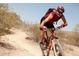 Personal is mountain biking in the hills of the surrounding area, wearing a backpack and helmet, on a sunny day at 18178 W Desert View Ln, Goodyear, AZ 85338