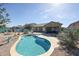 Backyard featuring a swimming pool, patio and desert landscaping at 18178 W Desert View Ln, Goodyear, AZ 85338