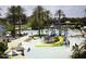 A resort-style waterpark pool area with a slide and playground, plus people enjoying the sun and water at 18178 W Desert View Ln, Goodyear, AZ 85338