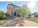 Well-manicured backyard with stone, patio, and lush landscaping, perfect for outdoor enjoyment at 18436 E Celtic Manor Dr, Queen Creek, AZ 85142