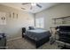 Bedroom with neutral walls, ceiling fan, and a large window at 18436 E Celtic Manor Dr, Queen Creek, AZ 85142