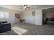 Another view of this bonus room, with a basketball themed game, comfortable seating, and lots of natural light at 18436 E Celtic Manor Dr, Queen Creek, AZ 85142