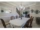 Elegant dining room with a chandelier, crown molding, and seating for six, creating a perfect spot for Gathering meals at 18436 E Celtic Manor Dr, Queen Creek, AZ 85142