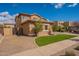 Charming two-story home with landscaped yard and inviting curb appeal under a sunny blue sky at 18436 E Celtic Manor Dr, Queen Creek, AZ 85142