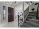 Inviting foyer with tile flooring, staircase with iron railings, and views of the adjacent dining room at 18436 E Celtic Manor Dr, Queen Creek, AZ 85142