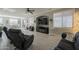 Comfortable living room featuring tile floors, plenty of windows and natural light, and comfortable seating at 18436 E Celtic Manor Dr, Queen Creek, AZ 85142