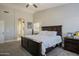 Spacious main bedroom featuring a king bed, soft carpet, and an en-suite bathroom at 18436 E Celtic Manor Dr, Queen Creek, AZ 85142