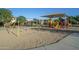 Community playground with swings, slides, and a shaded canopy for fun and safe play at 18436 E Celtic Manor Dr, Queen Creek, AZ 85142