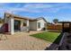 Well-maintained backyard featuring a covered patio and synthetic grass, perfect for outdoor enjoyment at 18502 N Celis St, Maricopa, AZ 85138