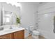 Bathroom featuring wood vanity, large mirror, and shower-tub combo with tile surround at 18502 N Celis St, Maricopa, AZ 85138