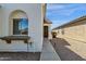 Close-up of the stucco exterior with an arched window and stone trim, enhancing curb appeal at 18502 N Celis St, Maricopa, AZ 85138