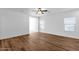 Bright living room featuring wood-look flooring, neutral walls, and natural light from multiple windows creating a cozy space at 18502 N Celis St, Maricopa, AZ 85138