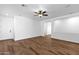 Spacious living room featuring hardwood floors, ceiling fan, and fresh, neutral paint at 18502 N Celis St, Maricopa, AZ 85138