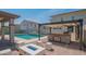 Outdoor entertaining space featuring a firepit, outdoor kitchen and a swimming pool at 18925 W Windsor Blvd, Litchfield Park, AZ 85340