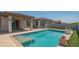 Inviting backyard pool and manicured landscaping featuring a covered patio and lush greenery at 18925 W Windsor Blvd, Litchfield Park, AZ 85340
