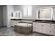 Elegant bathroom featuring double vanity, soaking tub, and bright, modern fixtures at 18925 W Windsor Blvd, Litchfield Park, AZ 85340