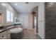Bathroom showcasing a tub, dual vanities with framed mirrors, and stylish tile flooring at 18925 W Windsor Blvd, Litchfield Park, AZ 85340