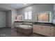 Elegant Primary bathroom featuring a soaking tub, dual vanities, and modern light fixtures at 18925 W Windsor Blvd, Litchfield Park, AZ 85340